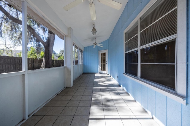 unfurnished sunroom with ceiling fan and lofted ceiling