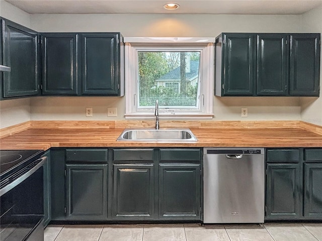 kitchen with sink, light tile patterned floors, and stainless steel appliances