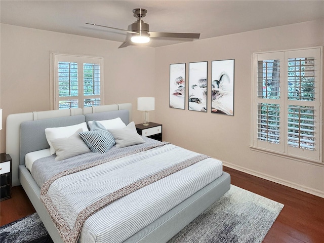 bedroom with ceiling fan and dark wood-type flooring