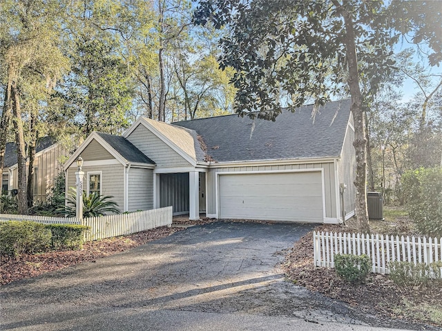 view of front of property with cooling unit and a garage