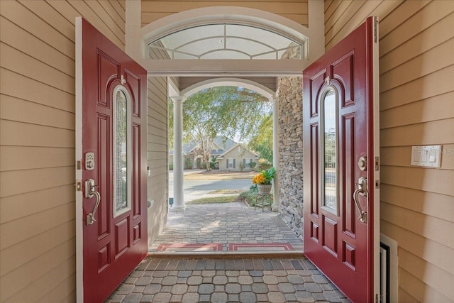 foyer with wood walls