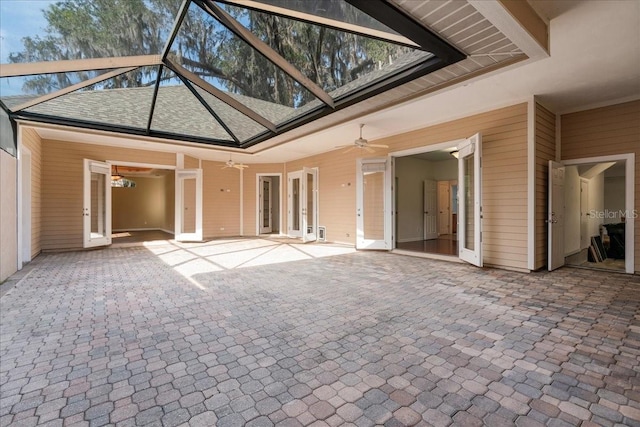 interior space with ceiling fan, a towering ceiling, carpet floors, and wood walls