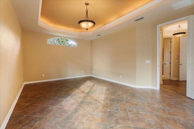 spare room featuring a raised ceiling