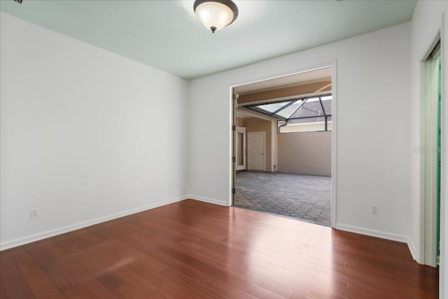 spare room featuring wood-type flooring