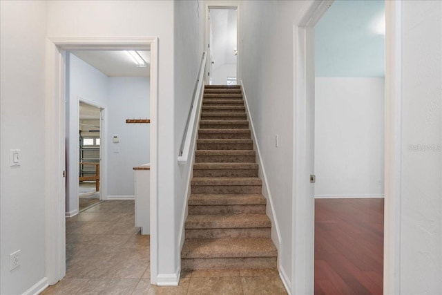 stairway with tile patterned floors