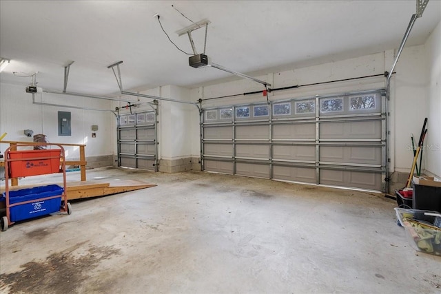 garage with a garage door opener and electric panel