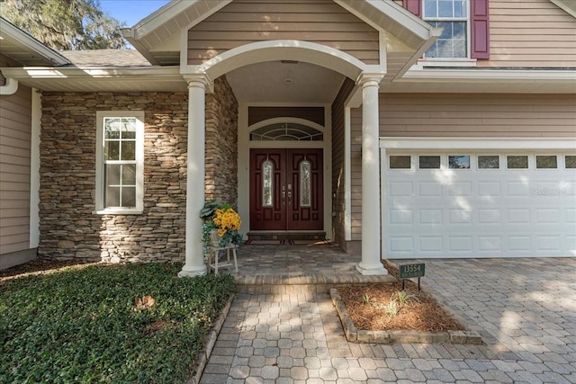 view of exterior entry with a garage