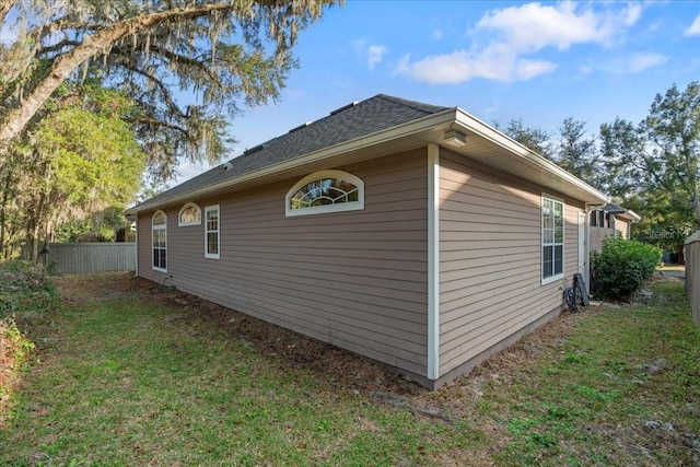 view of side of home featuring a lawn