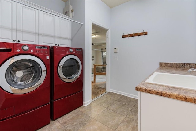 13554 NW 7th Rd, Newberry, FL 32669 - washroom featuring washer and clothes dryer, cabinet space, and light tile patterned flooring