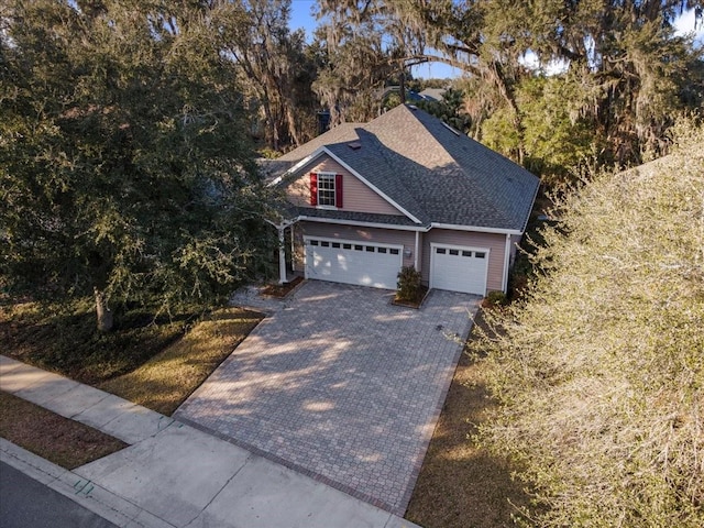 13554 NW 7th Rd, Newberry, FL 32669 - view of front facade with decorative driveway, roof with shingles, and an attached garage