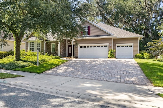 13554 NW 7th Rd, Newberry, FL 32669 - view of front facade with decorative driveway, a garage, and a front lawn
