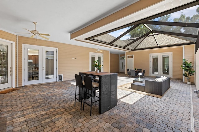13554 NW 7th Rd, Newberry, FL 32669 - view of patio featuring french doors, a ceiling fan, outdoor dining space, an outdoor living space, and glass enclosure