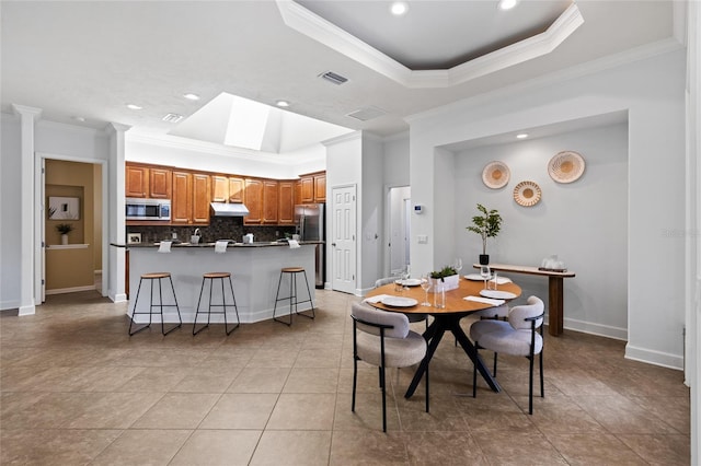 13554 NW 7th Rd, Newberry, FL 32669 - dining area featuring ornamental molding, a raised ceiling, a skylight, light tile patterned flooring, and recessed lighting