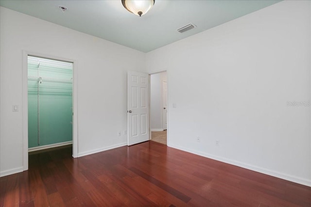 13554 NW 7th Rd, Newberry, FL 32669 - unfurnished bedroom featuring wood finished floors and a spacious closet