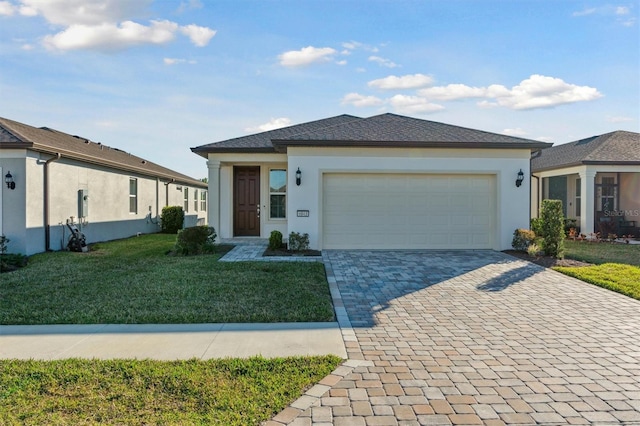 view of front of house with a garage and a front lawn