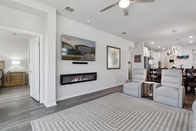 living room featuring hardwood / wood-style flooring and ceiling fan