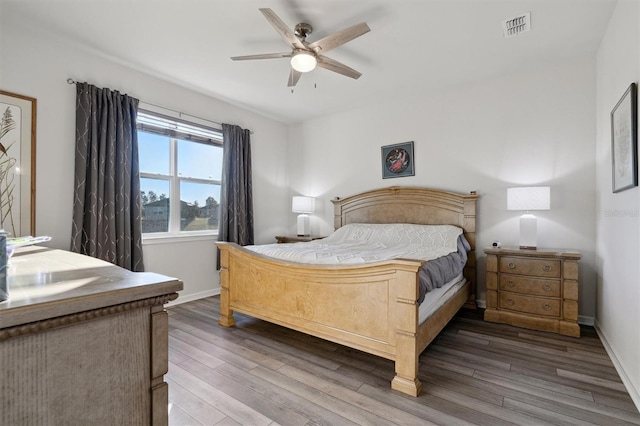 bedroom with ceiling fan and dark hardwood / wood-style floors