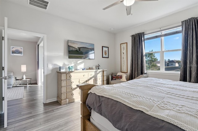 bedroom with light hardwood / wood-style flooring and ceiling fan