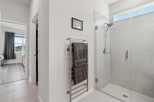 bathroom with tile patterned flooring and a shower with shower door