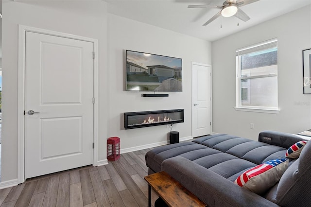 living room with hardwood / wood-style floors and ceiling fan