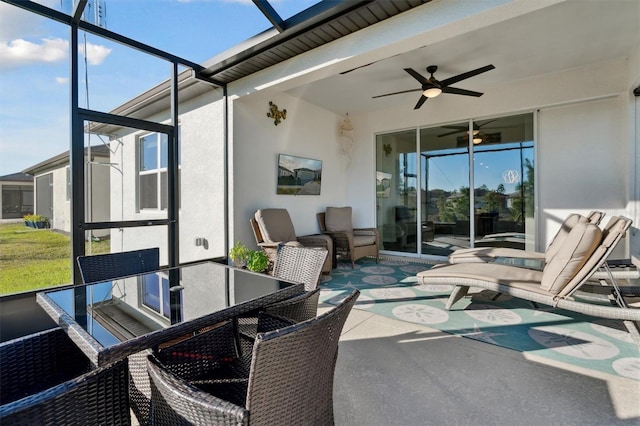 sunroom with ceiling fan and plenty of natural light