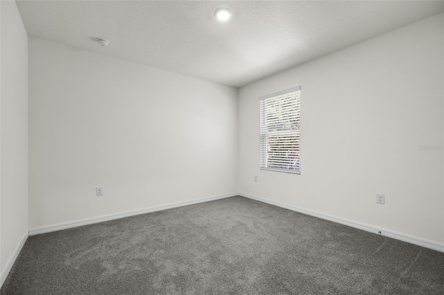 empty room with dark carpet