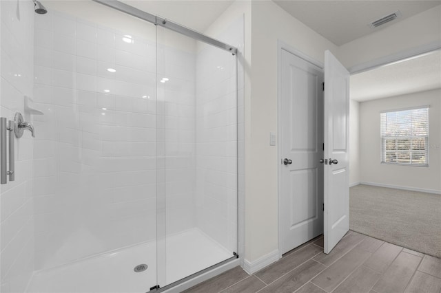 bathroom with a shower with shower door