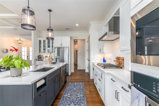 kitchen with sink, white cabinetry, decorative light fixtures, dark hardwood / wood-style flooring, and wall chimney range hood