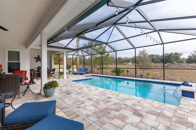 view of pool featuring an outdoor living space, ceiling fan, glass enclosure, and a patio area