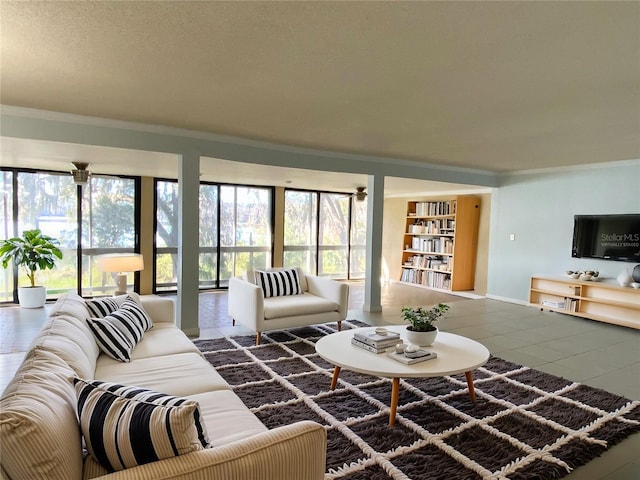 living room with tile patterned flooring and ornamental molding