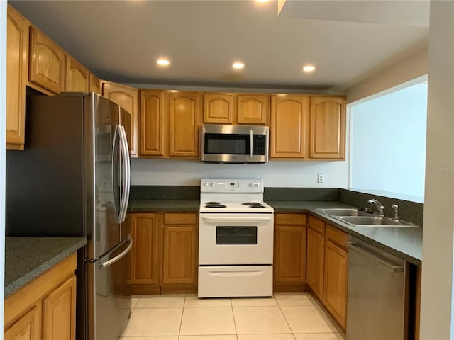 kitchen with sink, light tile patterned floors, and stainless steel appliances