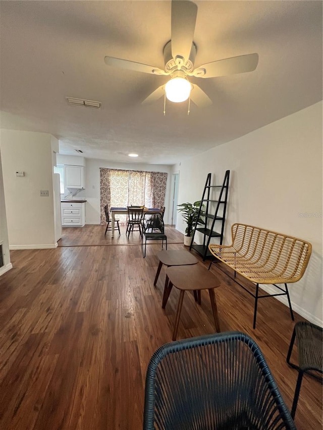 living area featuring hardwood / wood-style floors and ceiling fan