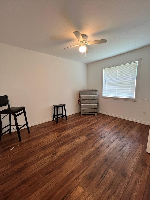 unfurnished room featuring ceiling fan and dark hardwood / wood-style flooring