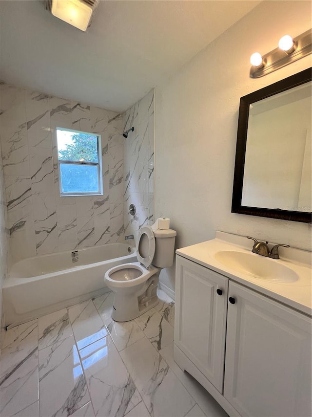 full bathroom with toilet, vanity, and tiled shower / bath