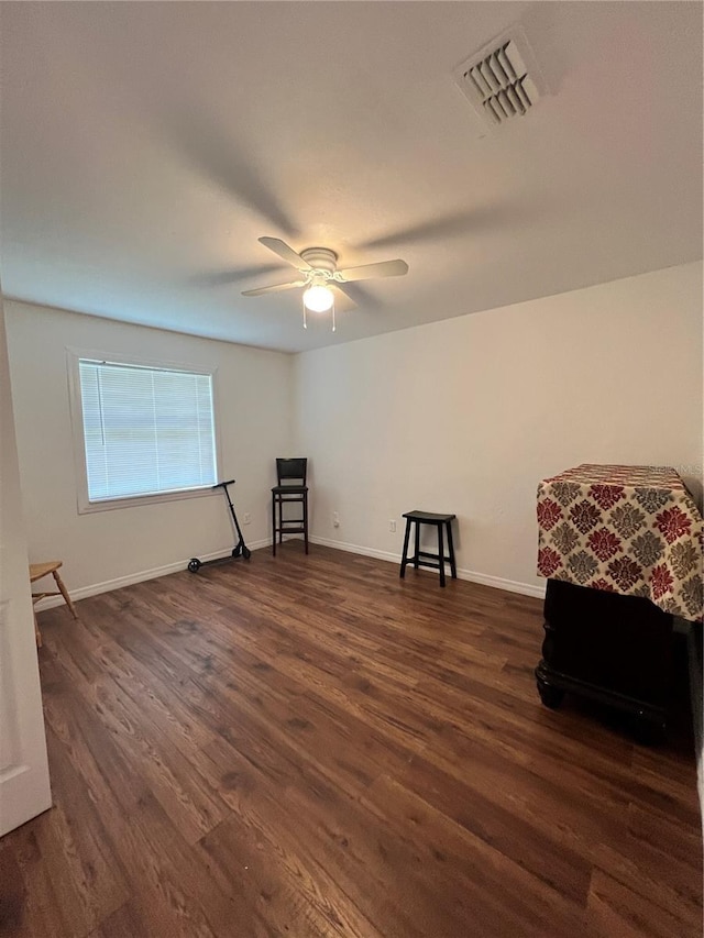 unfurnished room featuring ceiling fan and dark hardwood / wood-style flooring