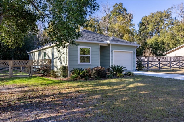 ranch-style house featuring a garage and a front yard