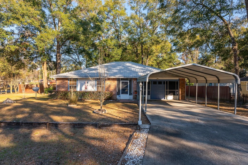 single story home featuring a garage and a carport