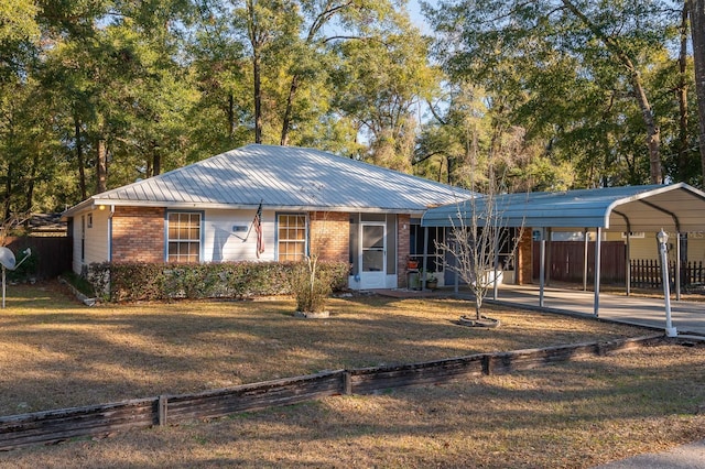 single story home with a front yard and a carport