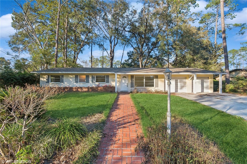 single story home featuring a garage and a front lawn