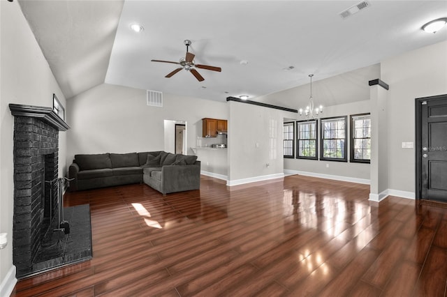 unfurnished living room featuring vaulted ceiling, a fireplace, dark wood finished floors, and visible vents