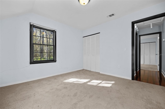 unfurnished bedroom with baseboards, a closet, visible vents, and carpet flooring