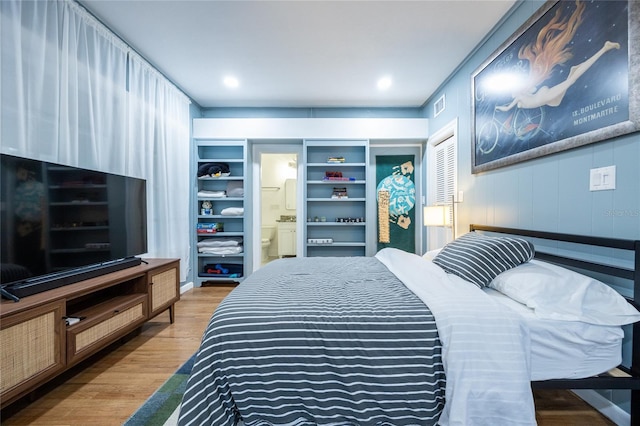 bedroom with hardwood / wood-style floors