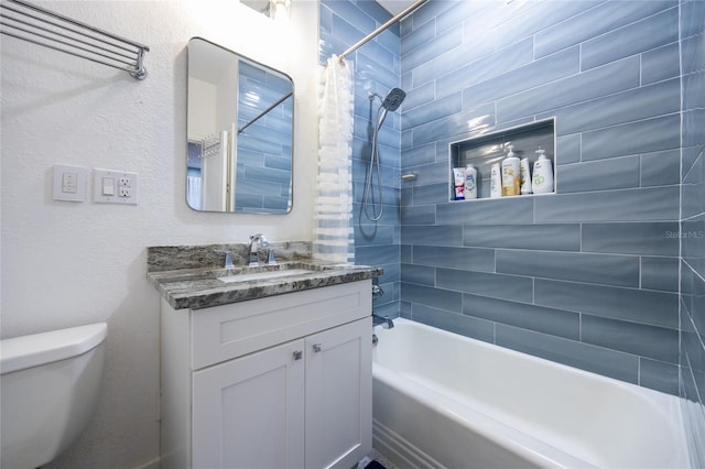 full bathroom featuring vanity, shower / bath combination with curtain, and toilet