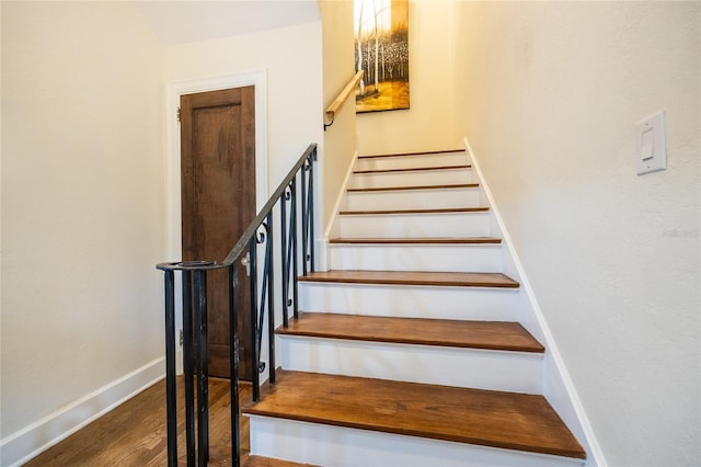 stairs featuring hardwood / wood-style flooring