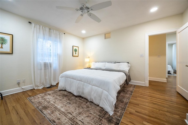 bedroom with ceiling fan and dark hardwood / wood-style flooring