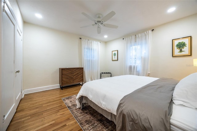 bedroom featuring light hardwood / wood-style flooring and ceiling fan