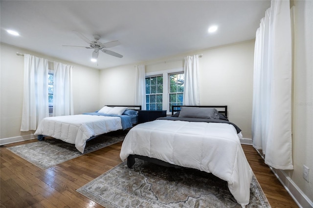 bedroom featuring ceiling fan and dark hardwood / wood-style floors