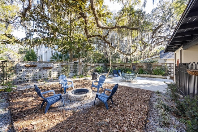 view of yard featuring an outdoor fire pit and a patio