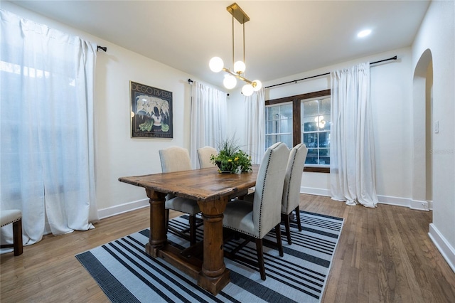 dining room featuring hardwood / wood-style flooring and a notable chandelier