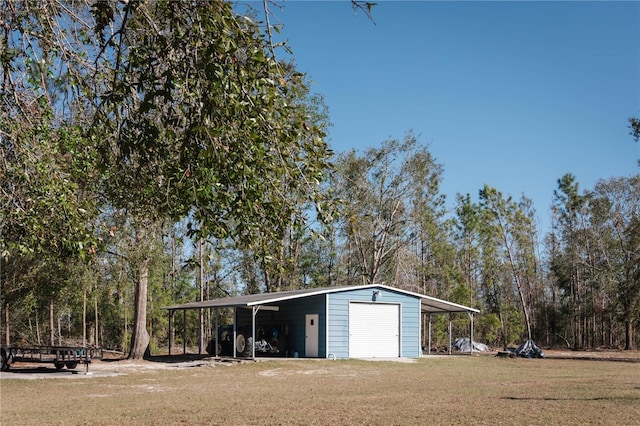 garage featuring a yard and a carport